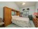 Cozy bedroom features a built in wardrobe, plush carpeting, and a large window at 9405 Palm Haven Ct, New Port Richey, FL 34655