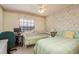 Guest bedroom with two twin beds, a desk and an office chair at 9405 Palm Haven Ct, New Port Richey, FL 34655