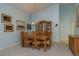 Bright dining room with a wood table, upholstered chairs, and a china cabinet at 9405 Palm Haven Ct, New Port Richey, FL 34655