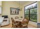 Dining room with an updated chandelier, a round table, and a large window at 9405 Palm Haven Ct, New Port Richey, FL 34655
