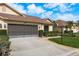 Single Gathering home featuring a two car garage, tidy landscaping, and a well maintained lawn at 9405 Palm Haven Ct, New Port Richey, FL 34655