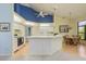 Eat-in kitchen featuring white cabinets and appliances, a breakfast bar, and vaulted ceilings at 9405 Palm Haven Ct, New Port Richey, FL 34655