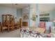 Open-concept living room featuring a dining area, comfortable seating, and high ceilings at 9405 Palm Haven Ct, New Port Richey, FL 34655