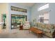 Bright living room with a sliding glass door to screened porch, vaulted ceiling, and lots of natural light at 9405 Palm Haven Ct, New Port Richey, FL 34655