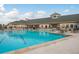Large swimming pool with ample deck space and lounge chairs, adjacent to the clubhouse at 9405 Palm Haven Ct, New Port Richey, FL 34655