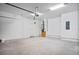Spacious two car garage featuring bright lighting, white walls, and ample space at 10194 Littlefield Ln, Spring Hill, FL 34608