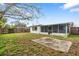 The expansive backyard features a screened-in porch, offering space to relax and enjoy the outdoors at 10736 Queens Rd, Port Richey, FL 34668