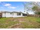 Backyard featuring a screened-in porch and wooden fence surrounding the property at 10736 Queens Rd, Port Richey, FL 34668