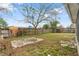 Spacious backyard with a large tree providing ample shade and a wooden fence surrounding the yard at 10736 Queens Rd, Port Richey, FL 34668