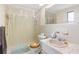 Bathroom features a shower-tub combo, toilet, and single sink with vanity at 10736 Queens Rd, Port Richey, FL 34668