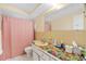 Bathroom includes a shower-tub combo, vanity, and colorful counter at 10736 Queens Rd, Port Richey, FL 34668