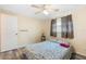 Cozy bedroom with a ceiling fan, a floral bedspread and natural light from the window at 10736 Queens Rd, Port Richey, FL 34668