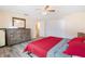 Bedroom boasts wood floors, a dresser, and a closet for storage at 10736 Queens Rd, Port Richey, FL 34668