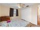 Bedroom with a closet, wood-look floors, and a ceiling fan at 10736 Queens Rd, Port Richey, FL 34668