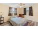 Bedroom with wood-look floors, ceiling fan, and two windows at 10736 Queens Rd, Port Richey, FL 34668