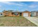 Charming single-story home features an attached garage and a well-maintained front yard at 10736 Queens Rd, Port Richey, FL 34668