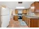 Bright kitchen features laminate flooring and a neutral color palette at 10736 Queens Rd, Port Richey, FL 34668
