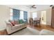 Bright living room with blue curtains, a sofa, and a dining area at 10736 Queens Rd, Port Richey, FL 34668