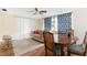 Cozy living room features wood floors, a ceiling fan, and bright natural light at 10736 Queens Rd, Port Richey, FL 34668