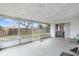 Enclosed patio with glass windows and sliding door leading to outdoor area at 10736 Queens Rd, Port Richey, FL 34668