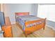 Bedroom showcasing a wood sleigh bed, wood flooring, dresser, and natural light from window at 10936 Keys Gate Dr, Riverview, FL 33579