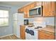 Well-equipped kitchen with modern appliances and wooden cabinets at 10936 Keys Gate Dr, Riverview, FL 33579