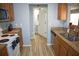 Kitchen with stainless steel appliances, granite countertops, and a view into the half bathroom at 10936 Keys Gate Dr, Riverview, FL 33579