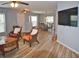 Open living room with chairs and a dining area, with a mounted flat screen TV at 10936 Keys Gate Dr, Riverview, FL 33579