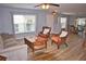 Living room showcasing tile flooring, large windows, sofa, chairs, and decorative coffee table at 10936 Keys Gate Dr, Riverview, FL 33579