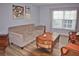 Living room featuring sofa, chairs, a coffee table, side tables and a window with natural light at 10936 Keys Gate Dr, Riverview, FL 33579
