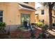 A cozy patio area with a chair and grill, enhanced by lush landscaping at 10936 Keys Gate Dr, Riverview, FL 33579