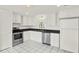 Bright kitchen with stainless steel appliances, black countertops, and ample cabinet space at 1106 40Th W Ave, Bradenton, FL 34205