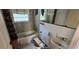 Bathroom with dated green tile, stained fixtures including a sink, toilet and bathtub, showing signs of needing repair at 11617 Duda Rd, Hudson, FL 34667