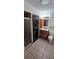 Compact bathroom featuring washer and dryer, shower stall, vanity, and toilet at 11617 Duda Rd, Hudson, FL 34667