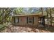 Exterior shot of house with covered area, grass and windows at 11617 Duda Rd, Hudson, FL 34667