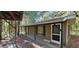 Exterior home view with a covered porch and natural light peering through the trees at 11617 Duda Rd, Hudson, FL 34667