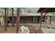 View of the back of the home; exterior of this home features a neutral color palette and wooded surroundings at 11617 Duda Rd, Hudson, FL 34667