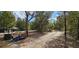 Exterior shot of property featuring a road and wooded landscape at 11617 Duda Rd, Hudson, FL 34667