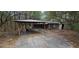 Exterior of house with a shed and attached carport at 11617 Duda Rd, Hudson, FL 34667