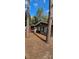 Side view of the home surrounded by mature trees; exterior of this home features a neutral color palette at 11617 Duda Rd, Hudson, FL 34667