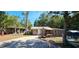 Cozy single-story home featuring a stone chimney, covered picnic area, and rustic charm at 11617 Duda Rd, Hudson, FL 34667