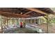 Rustic exterior with a covered carport, natural surroundings, and potential for customization at 11617 Duda Rd, Hudson, FL 34667