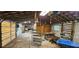 Large garage with storage and tools visible and exposed rafters at 11617 Duda Rd, Hudson, FL 34667