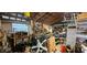 Interior of a cluttered garage featuring a wooden ceiling and window with many various items stored at 11617 Duda Rd, Hudson, FL 34667