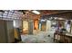 Expansive garage with exposed rafters, shelving, and scattered materials at 11617 Duda Rd, Hudson, FL 34667