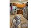 Inviting kitchen featuring wooden cabinets, tile countertops, and stainless steel appliances, with lots of natural light at 11617 Duda Rd, Hudson, FL 34667