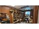 Interior office space featuring damaged ceiling, disorganized shelves, wood paneling, and natural light from the window at 11617 Duda Rd, Hudson, FL 34667
