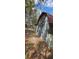 An exterior shot of a outbuilding, showing its weathered siding and old brick foundation at 11617 Duda Rd, Hudson, FL 34667
