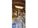 Interior shot of messy workshop with tools and wooden ceiling with hanging fluorescent light at 11617 Duda Rd, Hudson, FL 34667