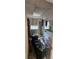 Outdated bathroom features a tub/shower combo, tiled walls and flooring, and storage space at 11617 Duda Rd, Hudson, FL 34667